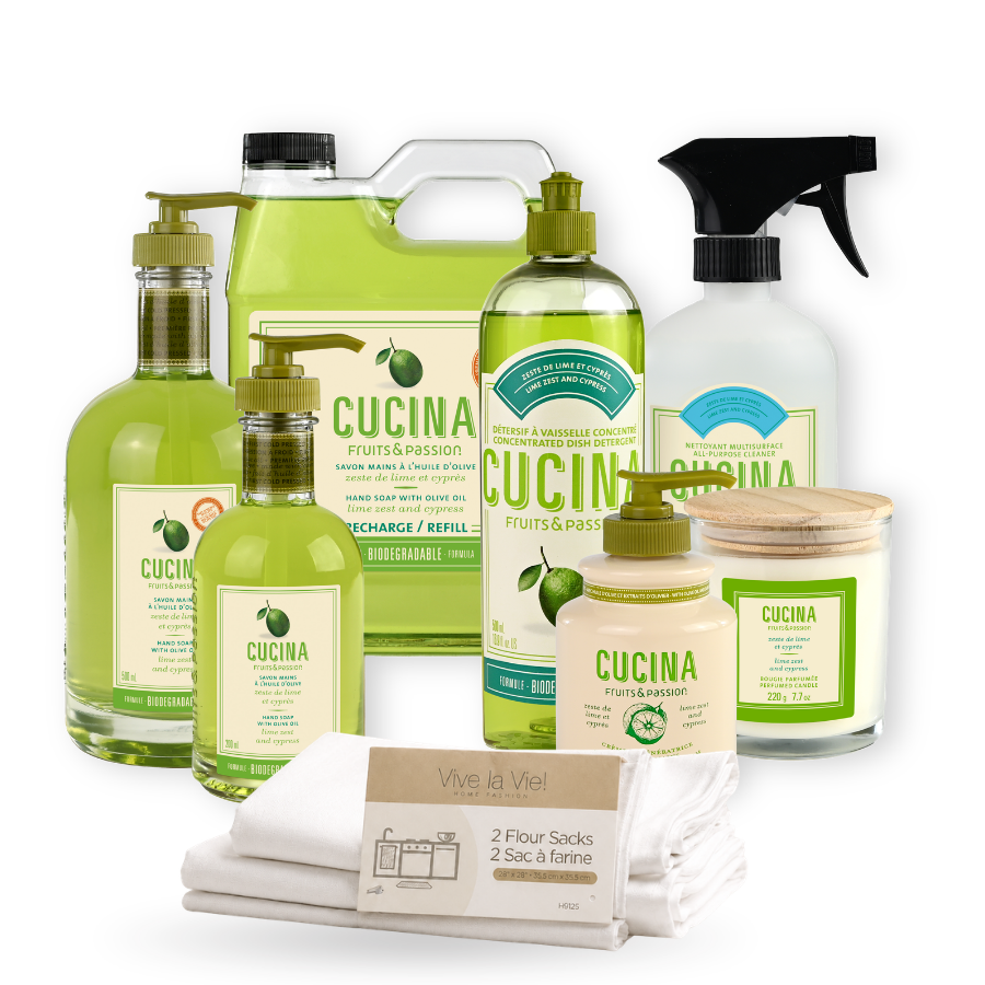 A CUCINA brand bath and body gift set featuring multiple products including a refillable citrus-scented soap dispenser, a refillable hand wash bottle, a spray bottle, a candle, and a folded white towel, arranged on a white background.